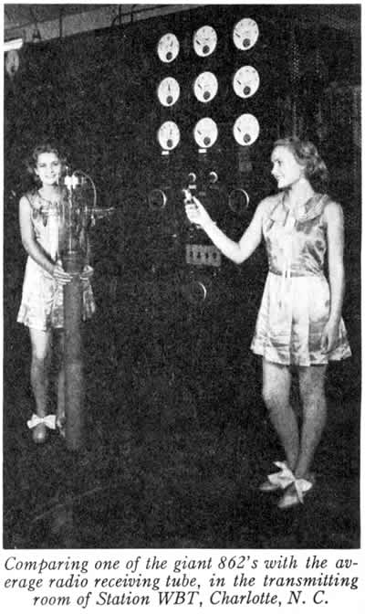 Comparing one of the giant 862's with the average receiving tube, in the transmitting room of Station WBT, Charlotte, N. C.